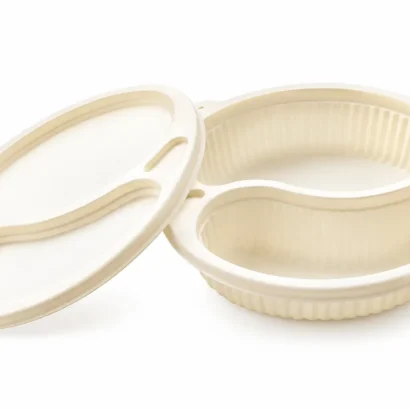 White circular contact lens case with two separate wells and a hinged lid laid open