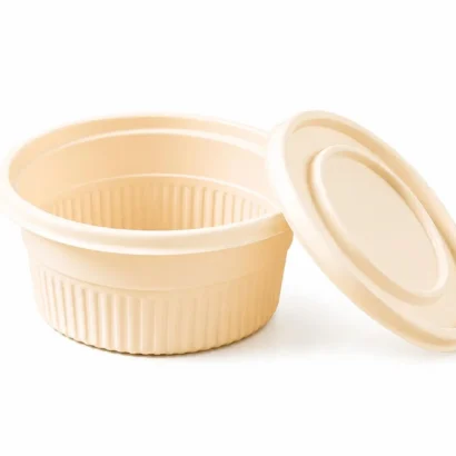 Beige plastic takeout container with a matching lid resting beside it on a white background