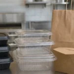Black plastic takeout container ban  black containers next to clear PP foil and kraft alternatives